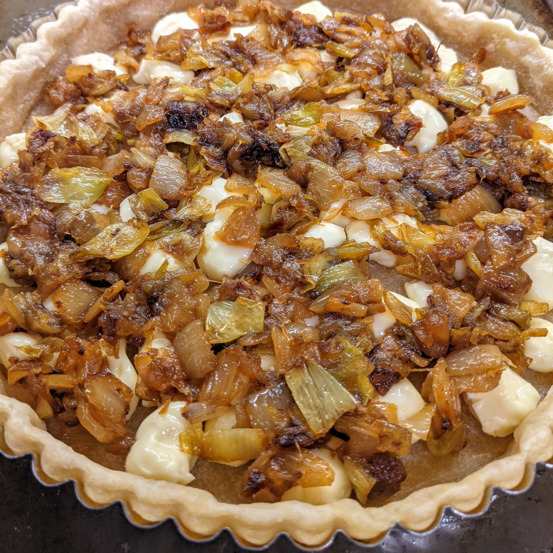 Caramelized leek and onion quiche, partially filled