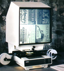 A microfiche machine displaying old newspaper ads