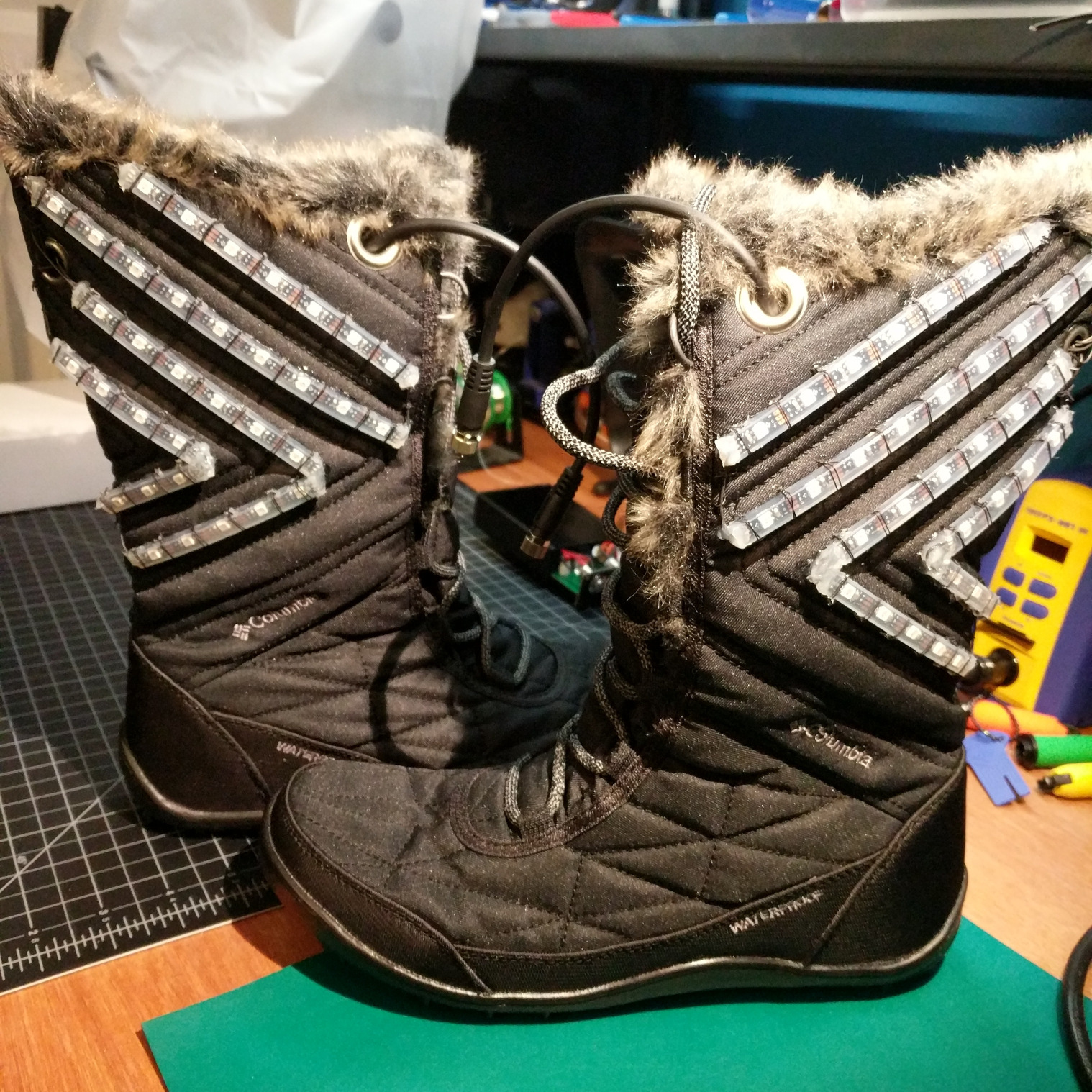 A pair of boots with LEDs and enclosures mounted