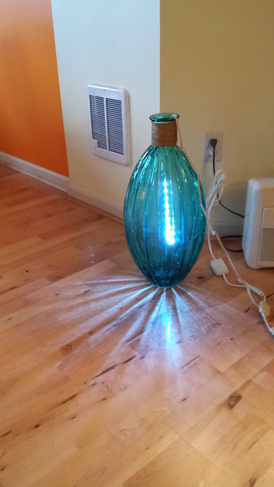 A large green vase with LEDs glowing inside
