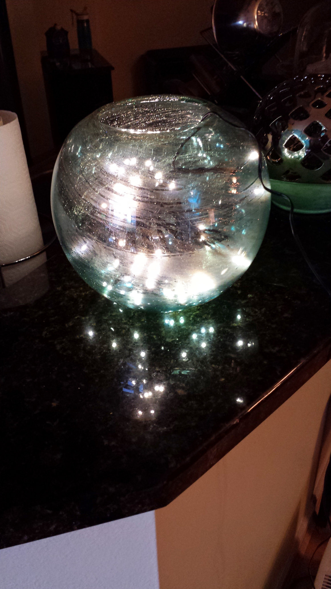 A glitter streaked glass globe with fairy lights inside