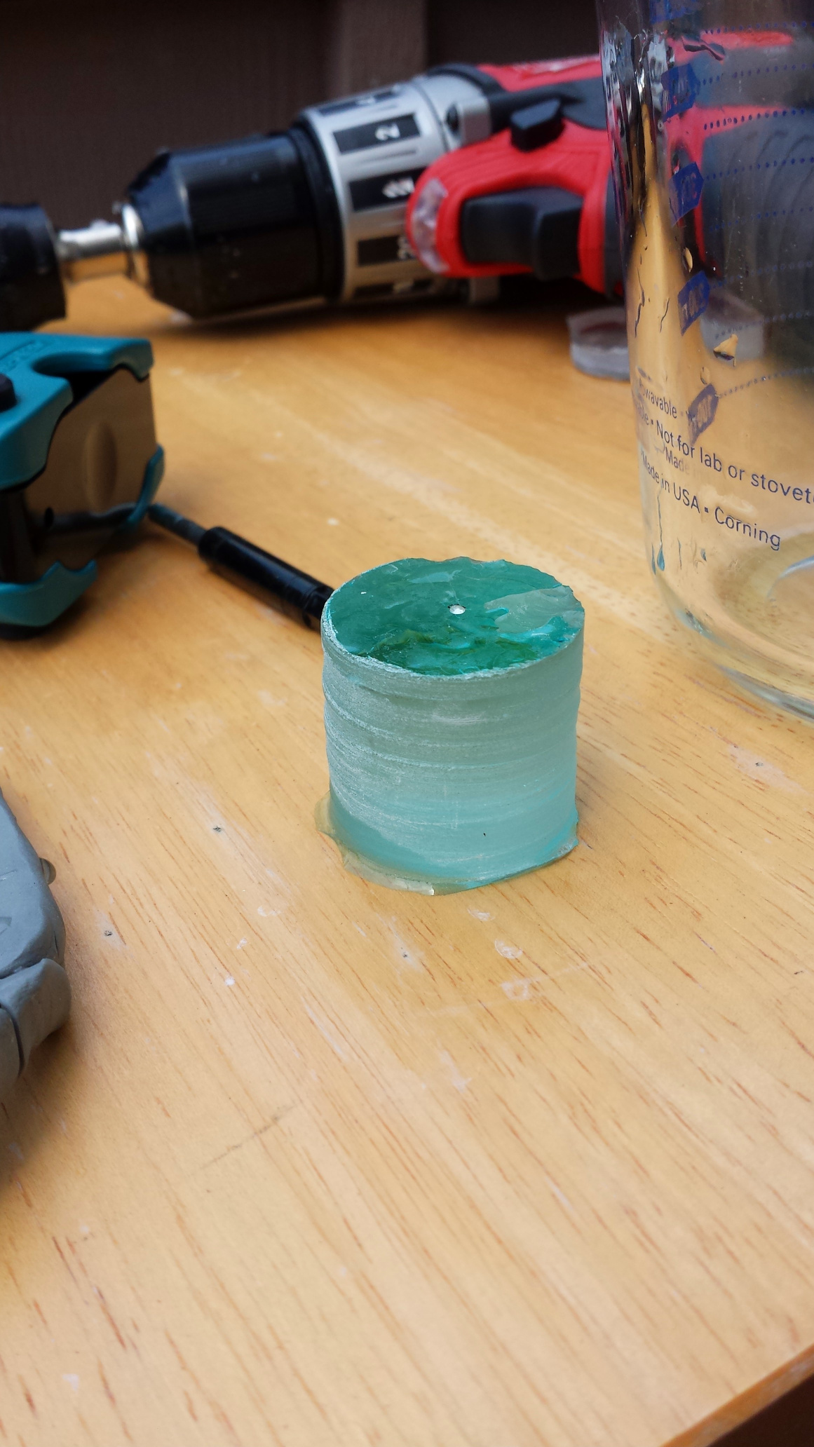a thick, 1.5 inch tall plug of green glass.